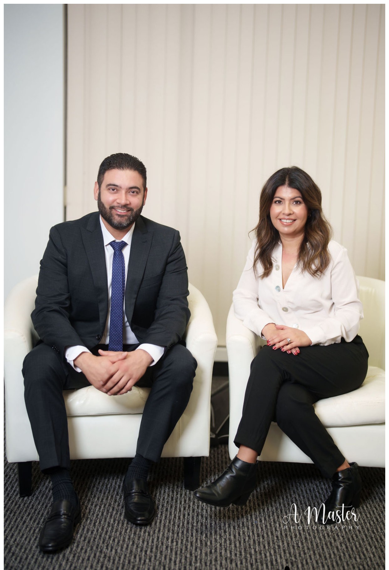 John and Gurwinder Gill seated in their office