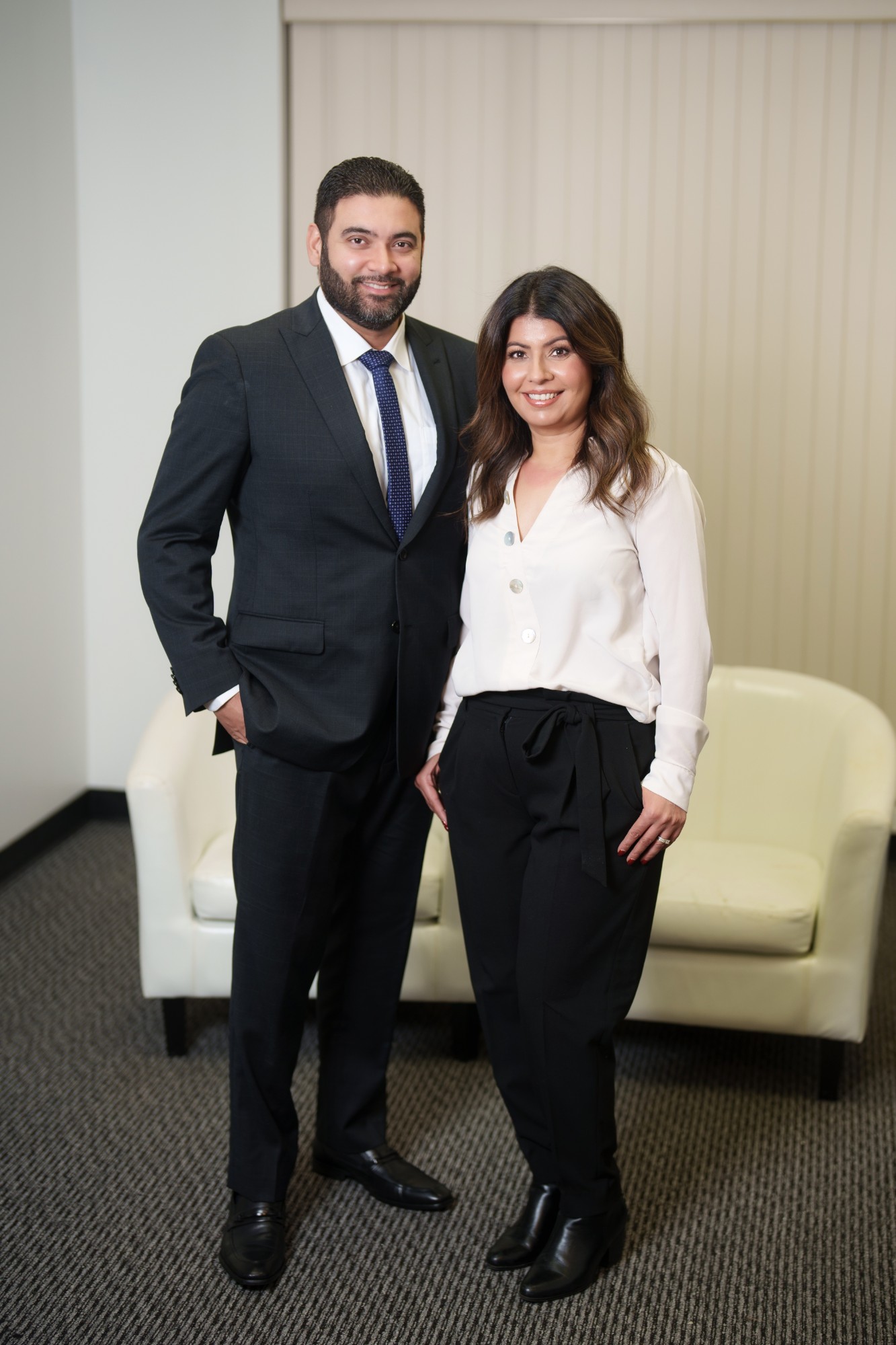 John and Gurwinder Gill standing together in their office