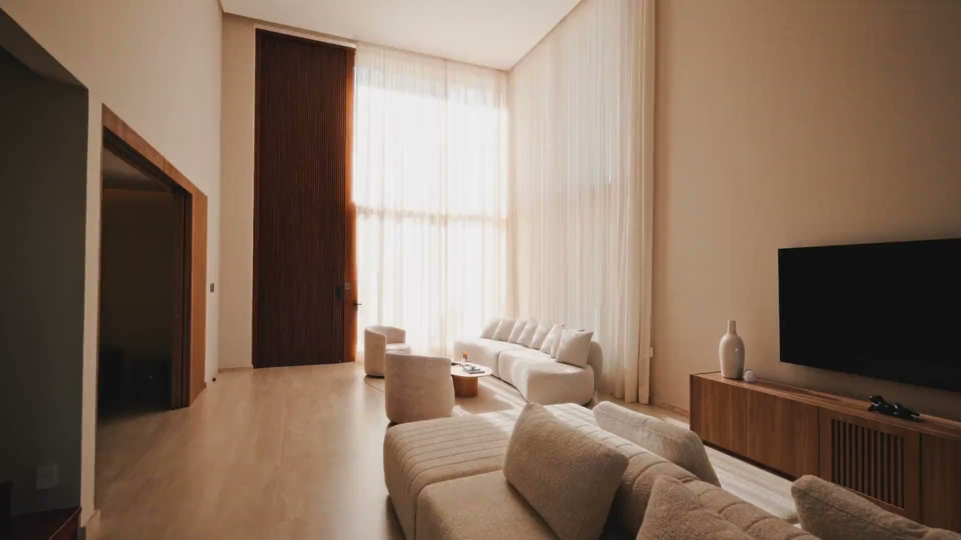 A quiet living room with light through sheer curtains