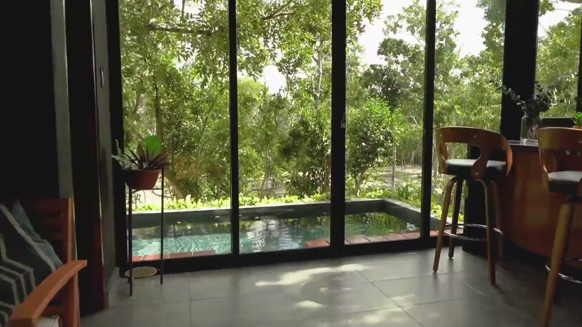 A covered terrace looking out onto trees